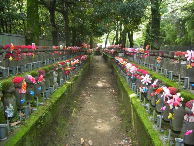 Rows of Jizo statues near the base of the Tokyo Tower